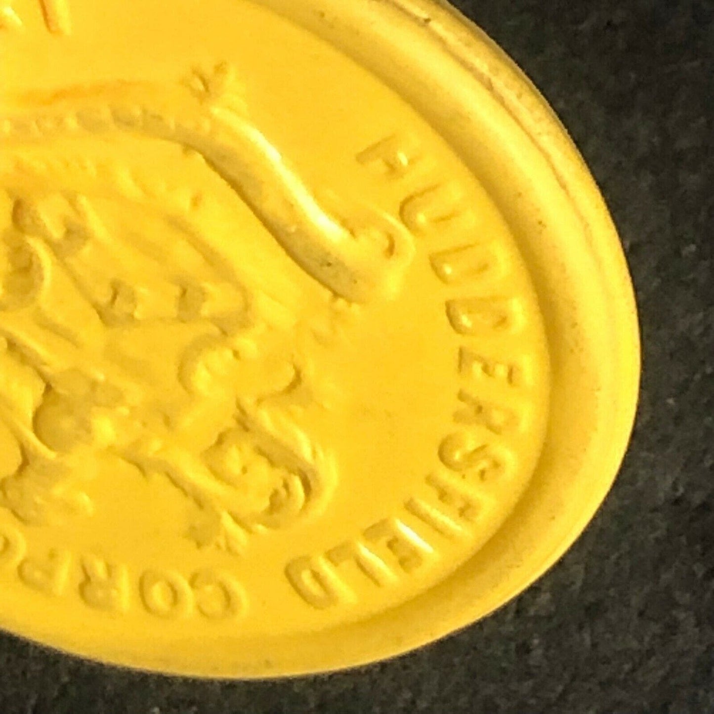 Huddersfield Transport England Plastic Token Yellow 1D 23mm c50's-60's