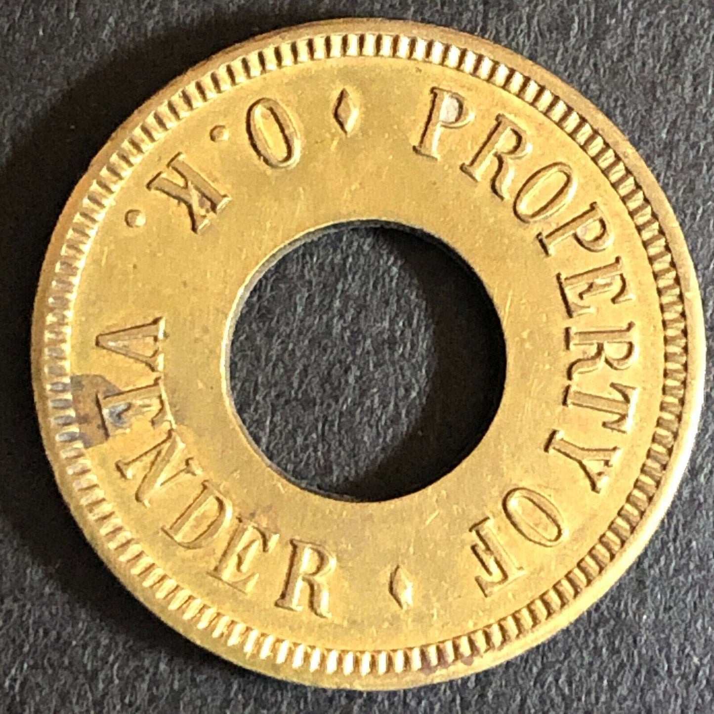 "O.K. Vender" Loaned for Amusement Only Brass Donut Game Token Star 21mm