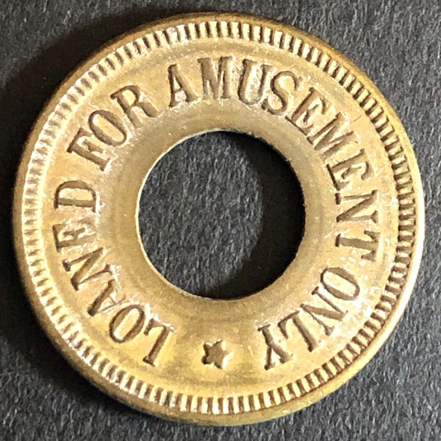 "O.K. Vender" Loaned for Amusement Only Brass Donut Game Token Star 21mm