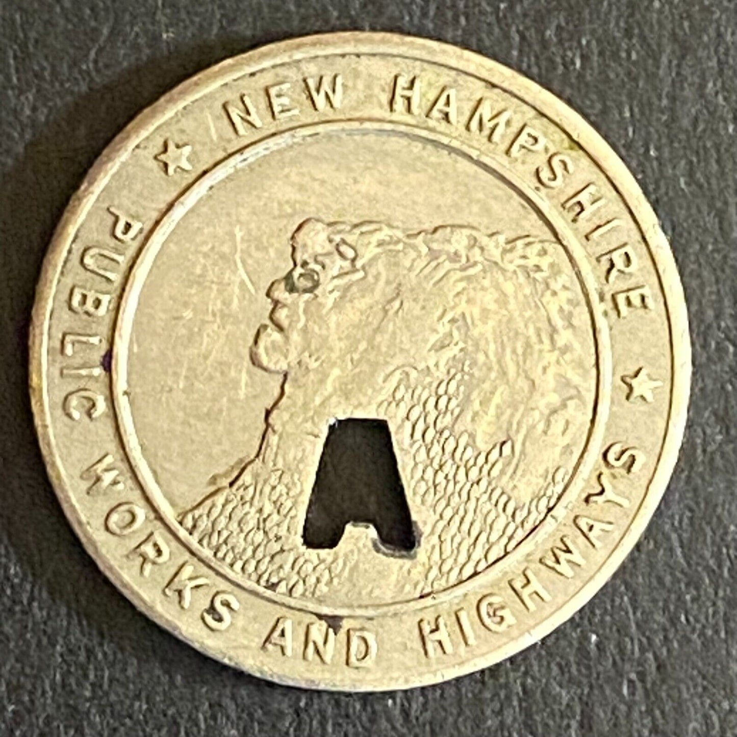 New Hampshire Public Works and Highways Transit Token w/ "A" Punch Out 16mm (#2)