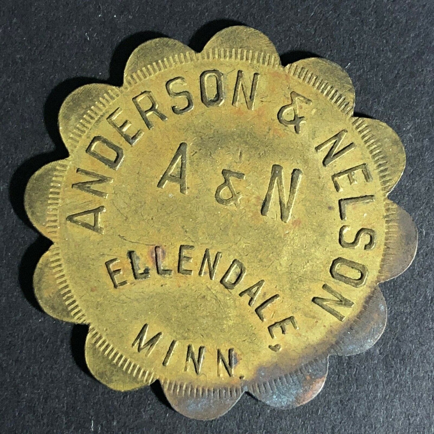 Anderson & Nelson Ellendale, Minn G/F $1 Brass Token 38mm Scalloped c1931-41
