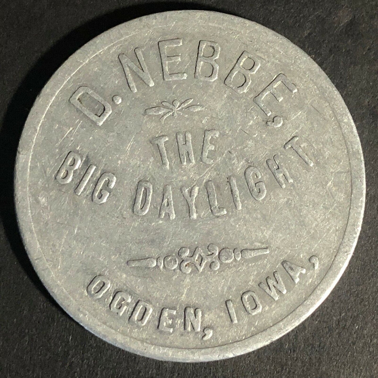 D. Nebbe Ogden IOWA "The Big Daylight" G/F $1 Merchandise Alum Token 38mm