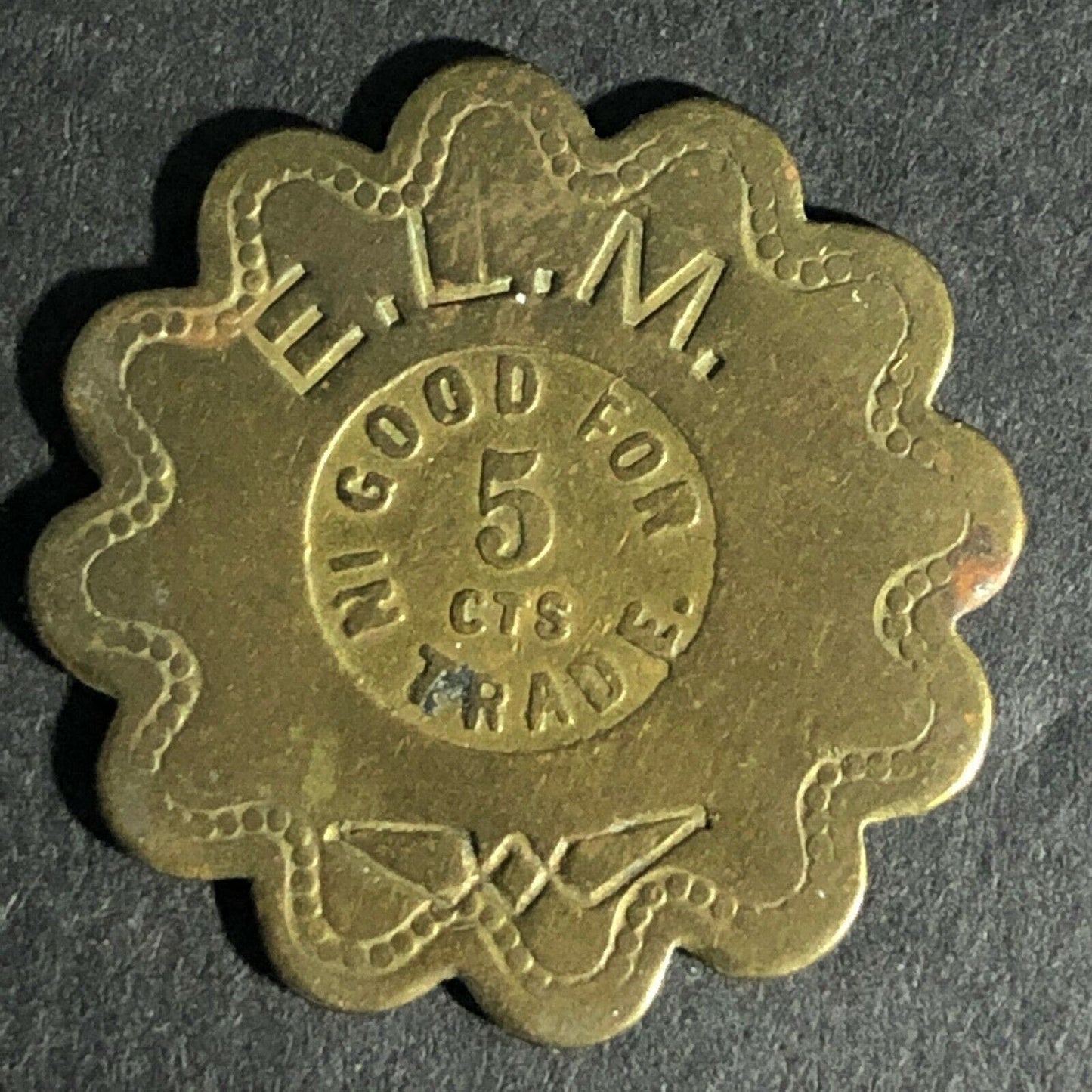 E.L.M. (E.L. McGarity Saloon San Francisco ?) G/F 5c Scalloped Brass Token 25mm