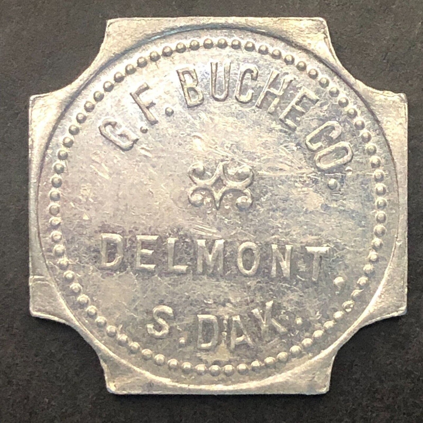 Delmont, SD "G.F. Buche Co." (Gen. Mdse.) G/F $1 Alum. Trade Token 25mm