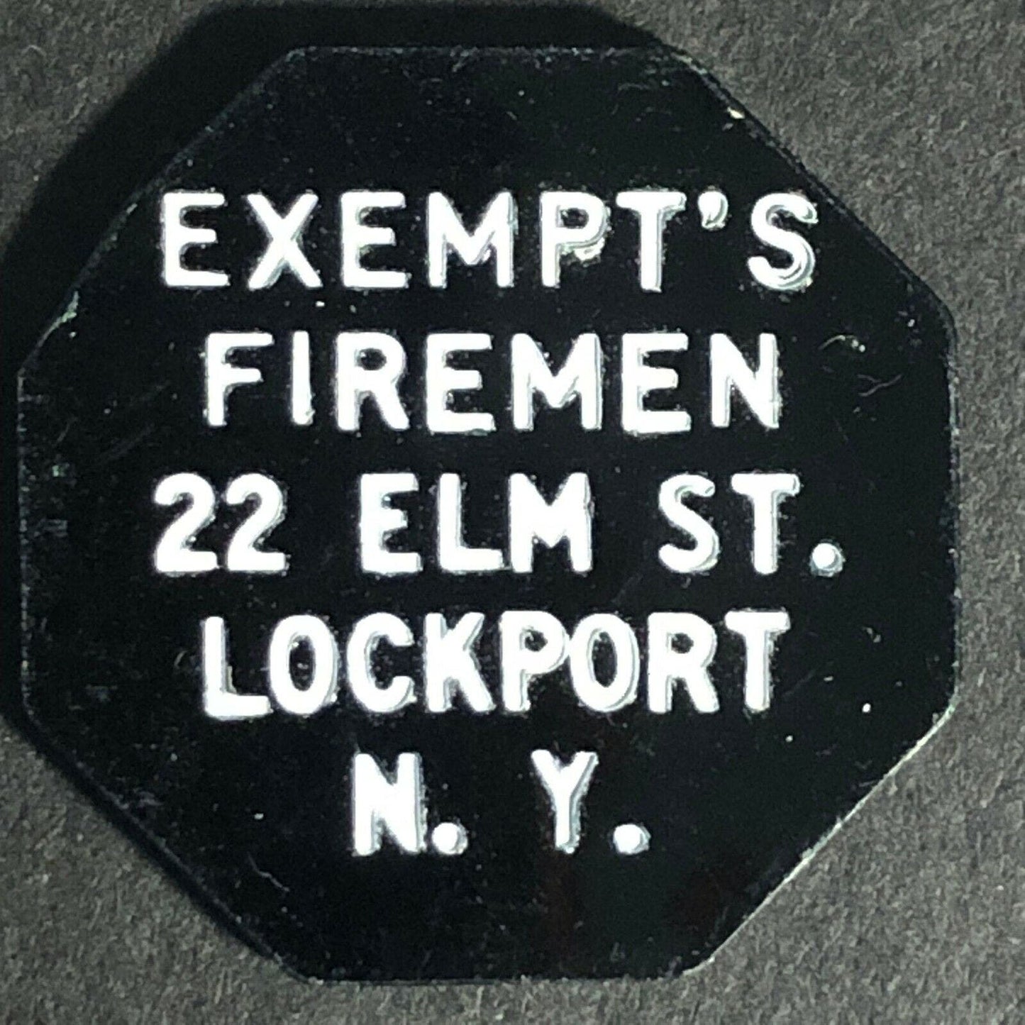 Lockport, NY Exempt's Firemen Plastic G/F 5c Octagonal Token c1960's-70's 23mm