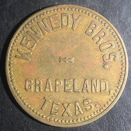 Kennedy Bros. Grapeland Texas G/F $1 Brass Trade Token (Est. c1909) 34.7mm